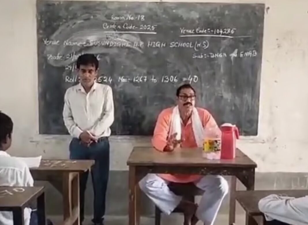 ক্লাসরুমের শিক্ষকের চেয়ারে বসে পড়ুয়াদের সামনে রাজনৈতিক ভাষণ বিজেপি নেতা সুব্রত গোস্বামীর, পাশে দাঁড়িয়ে শিক্ষক!