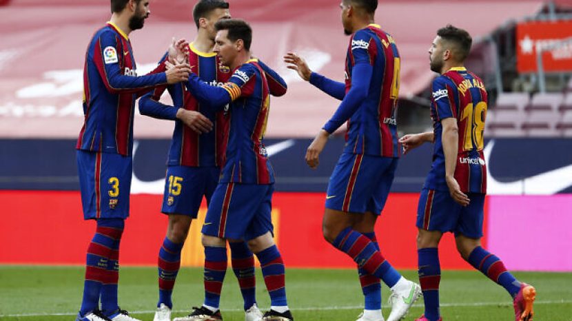 Barcelona's Lionel Messi celebrates with team mates scoring the opening goal during the Spanish La Liga soccer match between FC Barcelona and Celta at the Camp Nou stadium in Barcelona, Spain, Sunday, May. 16, 2021. (AP Photo/Joan Monfort)